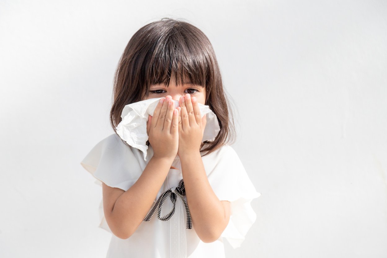 Asian Child Girl Sick with Sneezing on the Nose and Cold Cough O